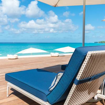 a group of lawn chairs sitting on top of a beach