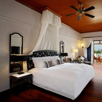 a bedroom with a bed and desk in a room