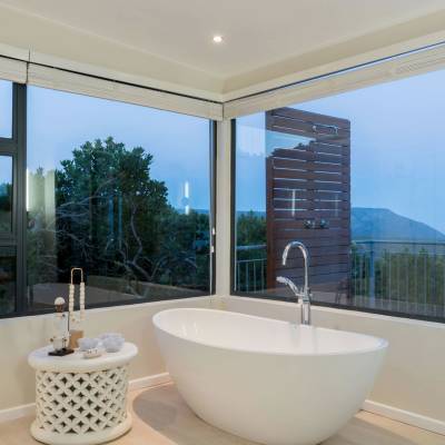 a large white tub next to a window
