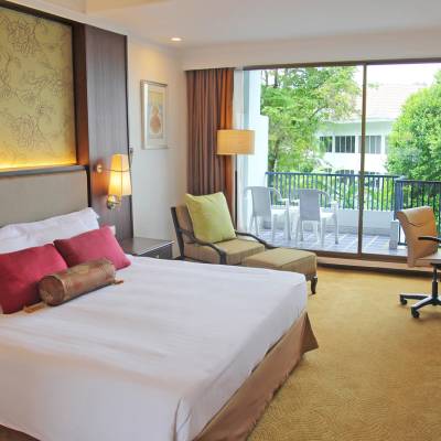 a bedroom with a large bed in a hotel room