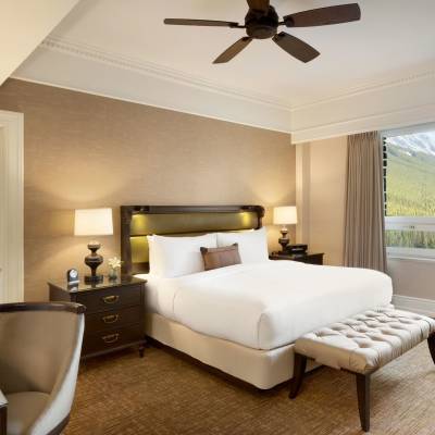 a hotel room filled with furniture and a large window
