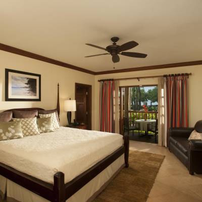 a bedroom with a bed and a mirror in a room