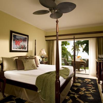 a bedroom with a bed and a chair in a room