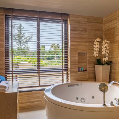 a large white tub sitting next to a window