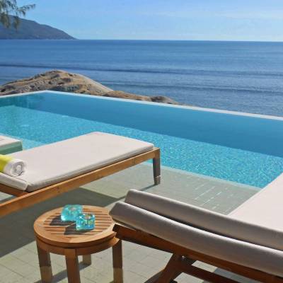a wooden bench sitting next to a body of water