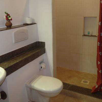 a white sink sitting under a mirror