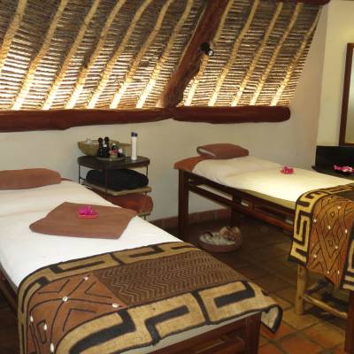 a bedroom with a bed and a chair in a room