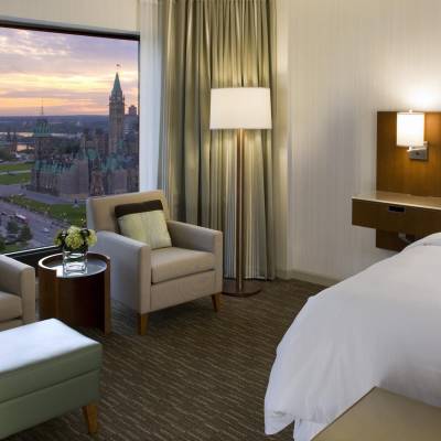 a bedroom with a large bed in a hotel room