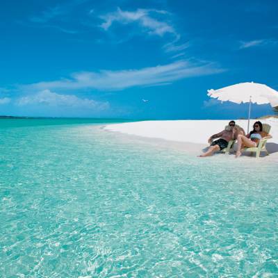 a blue umbrella next to a body of water