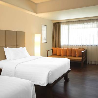 a bedroom with a large bed in a hotel room