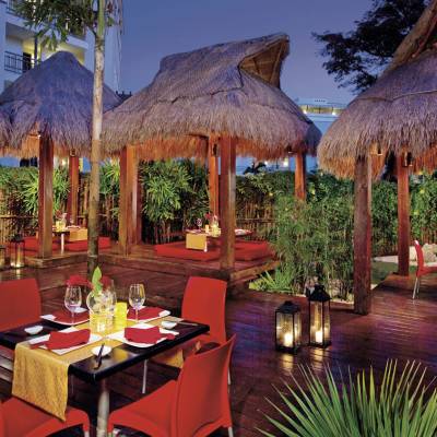 a dining table with a red umbrella