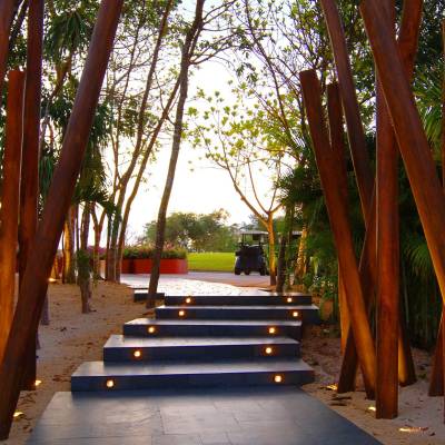 a row of wooden benches sitting on top of a sandy beach