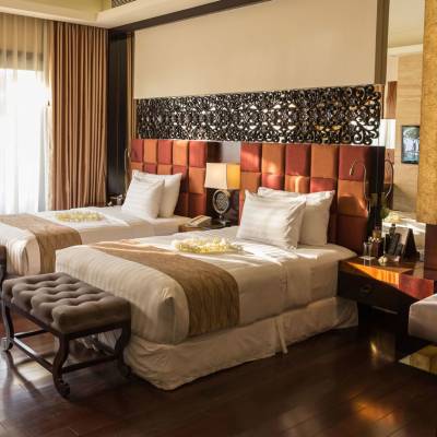 a bedroom with a large bed in a hotel room