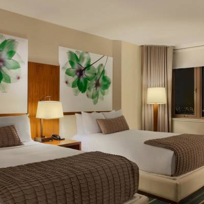 a hotel room filled with furniture and a flat screen tv