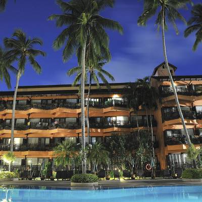 a palm tree in front of a building