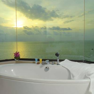a large white tub sitting next to a sink