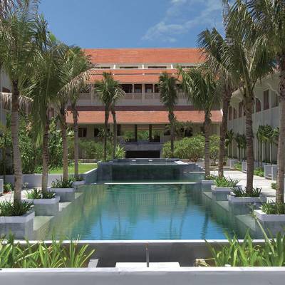 a house with a pool in front of a building