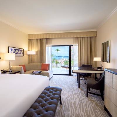 a bedroom with a bed and desk in a hotel room