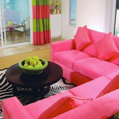a living room filled with furniture and a red chair