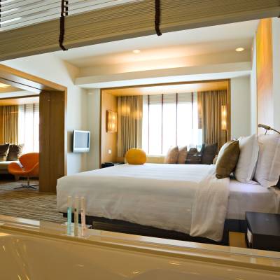 a bedroom with a bed and a mirror
