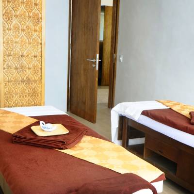 a bedroom with a bed and a chair in a room