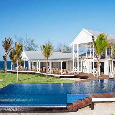 a house with a pool outside of a building