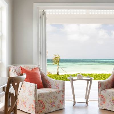 a view of a living room filled with furniture and a large window