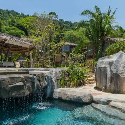 a stone building that has a pool of water