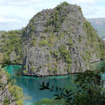 a body of water with a mountain in the background
