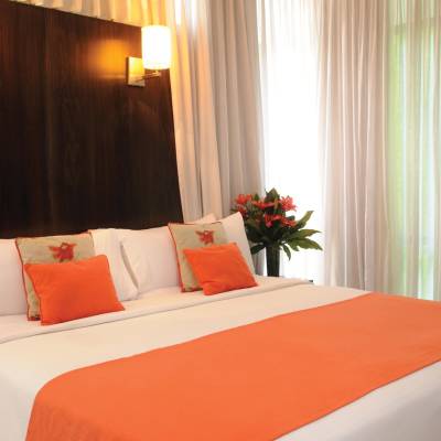 a red and white bed in a hotel room