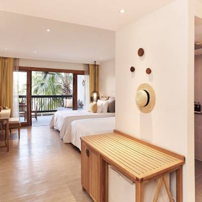 a bedroom with a bed and a mirror in a room