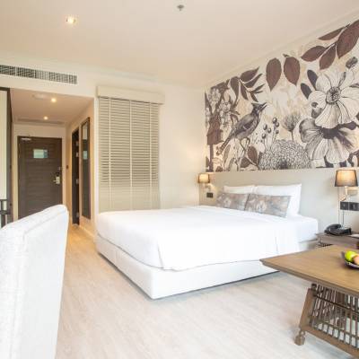 a bedroom with a bed and desk in a room