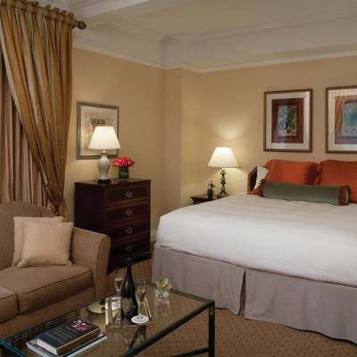 a hotel room with a flat screen tv sitting on top of a bed