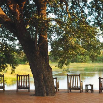 an empty park bench next to a body of water