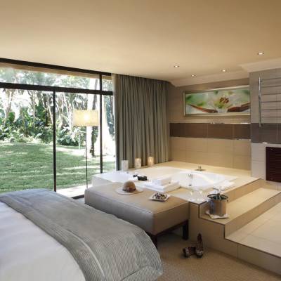 a hotel room with a bed and a large window