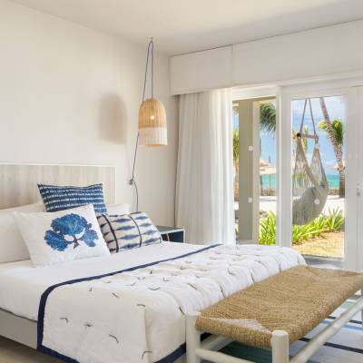 a bedroom with a bed and a chair in a room