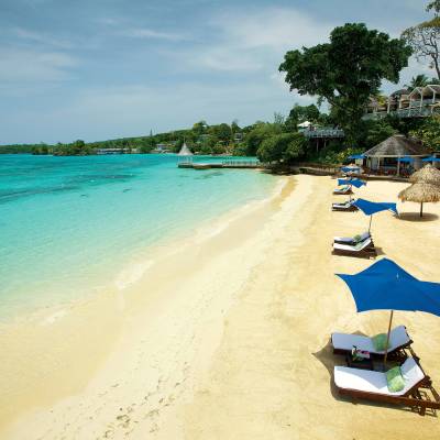 a sandy beach next to the water