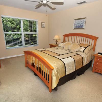 a bedroom with a bed and desk in a small room