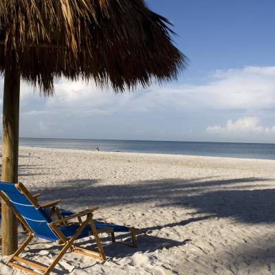 a person sitting on top of a sandy beach