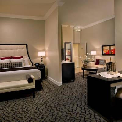 a bedroom with a bed and desk in a room