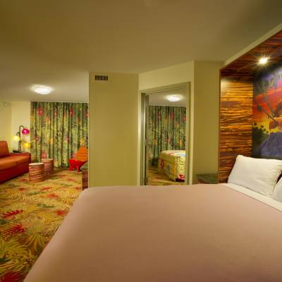a bedroom with a bed and looking at the camera