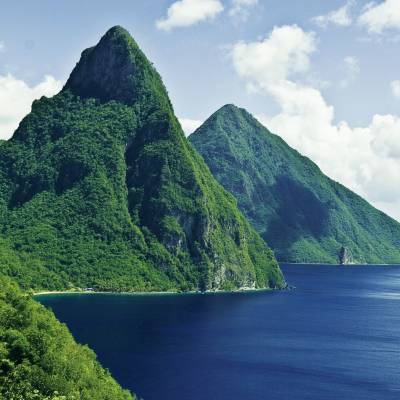 a large body of water with Pitons in the background
