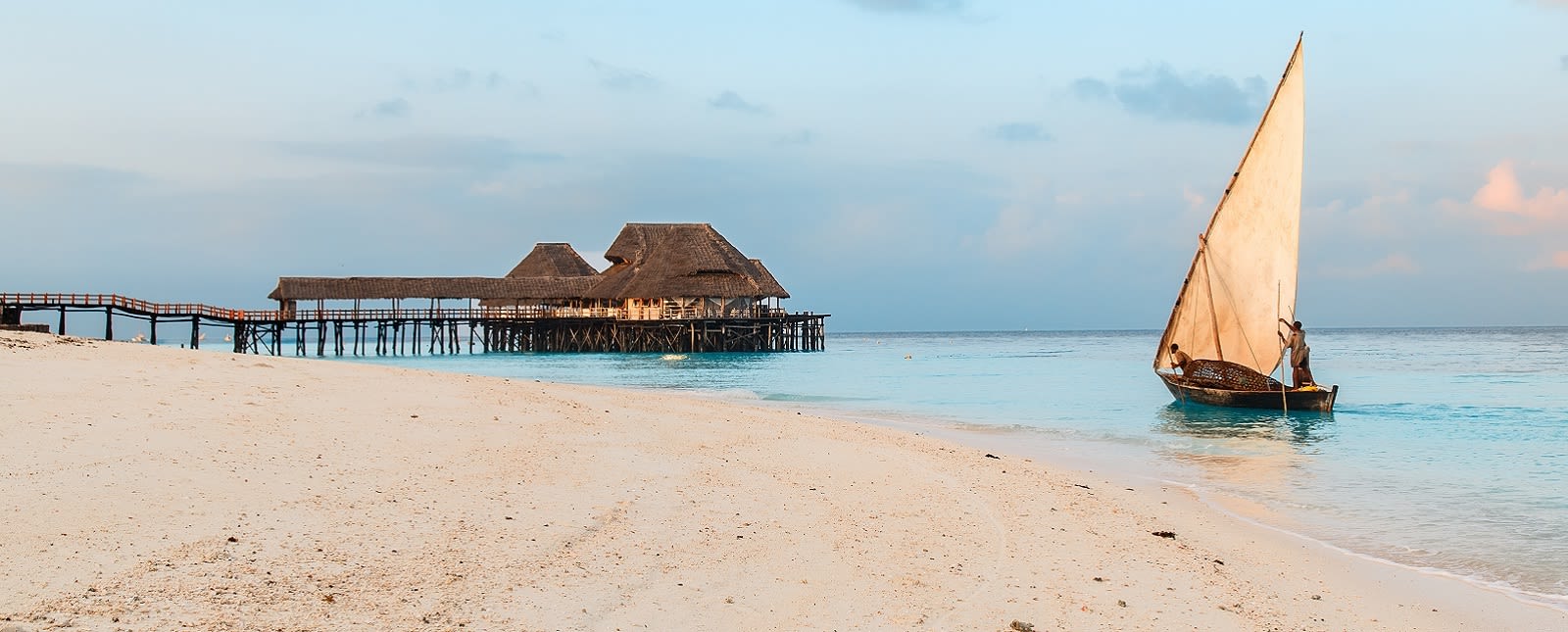 Beautiful sunrise over ocean with fishing boat, fishermen, hut, Nungwi, Kendwa, Zanzibar island, Tanzania Africa Tanzania travel