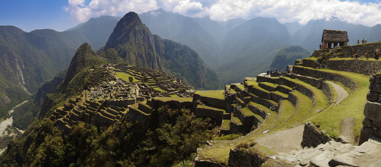 Panorama of Machu Picchu, Guard house, agriculture terraces, Wayna Picchu and surrounding mountains in the background Panorama of Machu Picchu, Guard house, agriculture terraces, Wayna Picchu and surrounding mountains in the background
