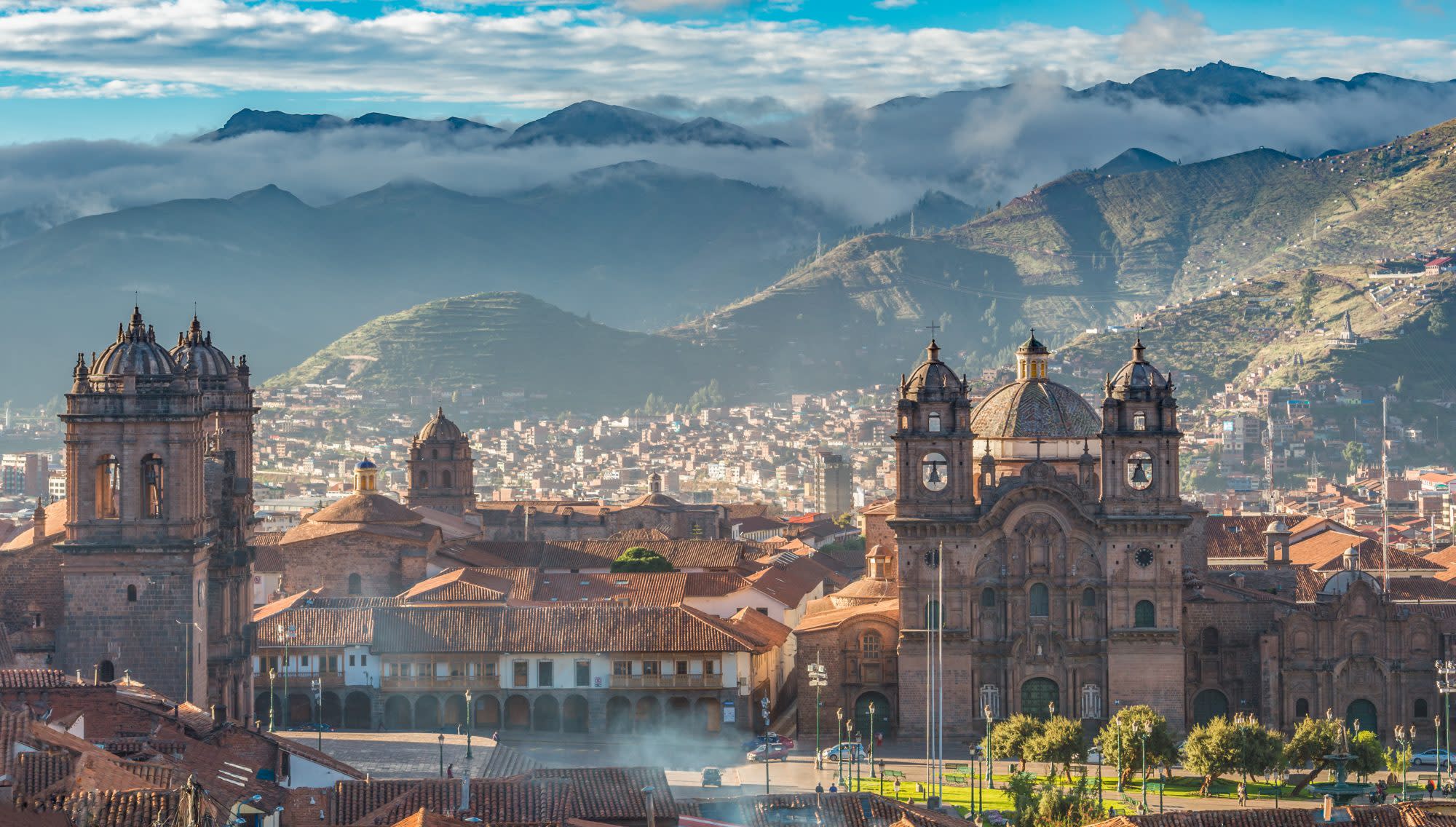 Morning sun rising at Plaza de armas with Adean Moutain and group of cloud, Cusco, Peru PERU TRAVEL GUIDE
