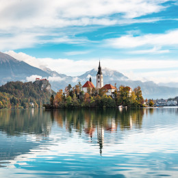 Church of Assumption in Lake Bled, Slovenia with blue sky and clouds in the autumn