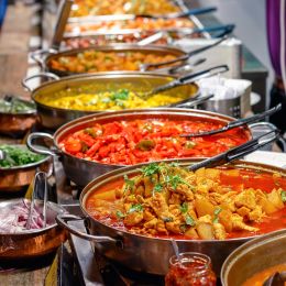 Enchanting Travels UK & Ireland Tours Variety of cooked curries on display at Camden Market in London