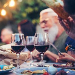 Australia Tours family eating and drinking red wine at dinner barbecue party outdoor