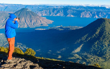 Enchanting Travels Guatemala ToursHiker with panorama view of Lake Atitlan and volcano San Pedro a