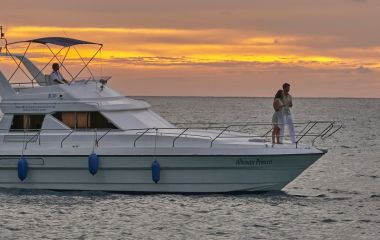 Couples enjoying in cruise during sunset